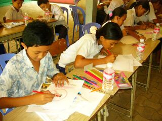 Children drawing messages and pictures regarding weapons and peace